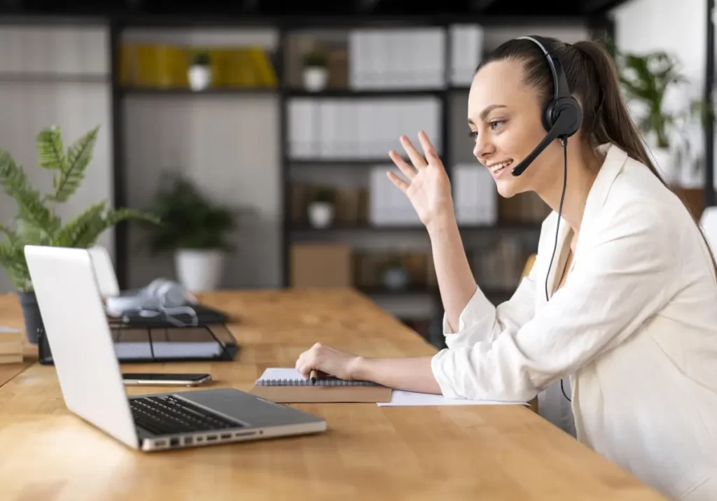 Virtual customer service assistant waving at a client through a video call