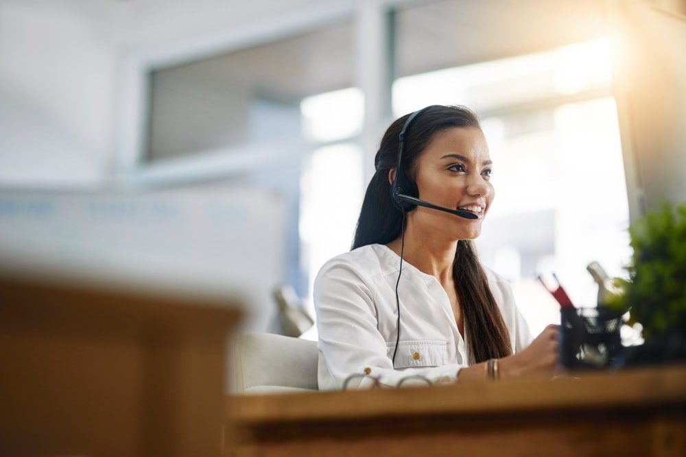 Female virtual assistant on a video call in sunny room