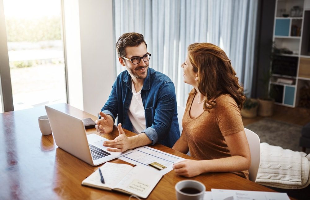 A couple of Virtual Assistants for Real Estate Agents discussing a project