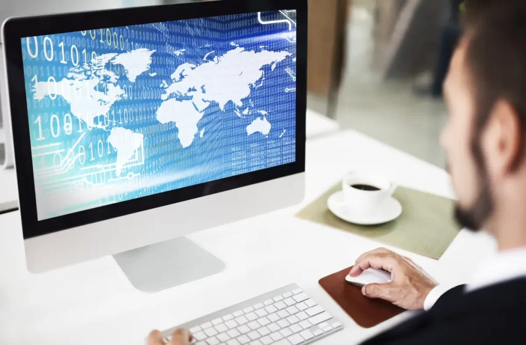 Man working remotely with a laptop at a desk