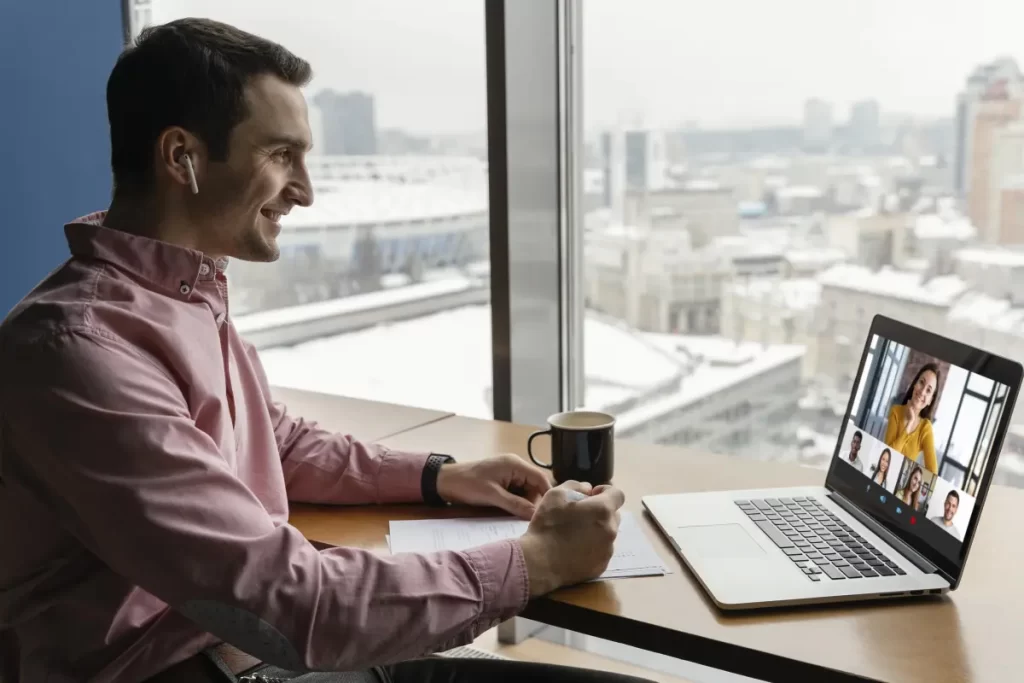 Man working remotely with a laptop at a desk