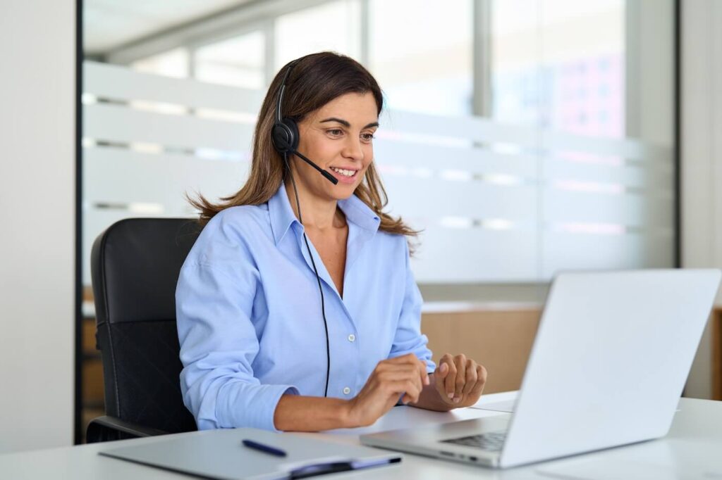 A middle-aged help desk operator talking to a customer